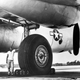 Closeup of the main landing gear. Standard human for scale.
